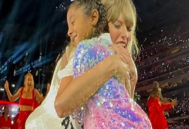 Taylor Swift trots up to a young fan belting out her song lyrics